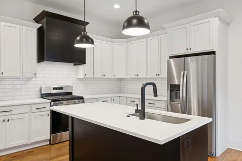 a view of a hallway with wooden floor and entryway