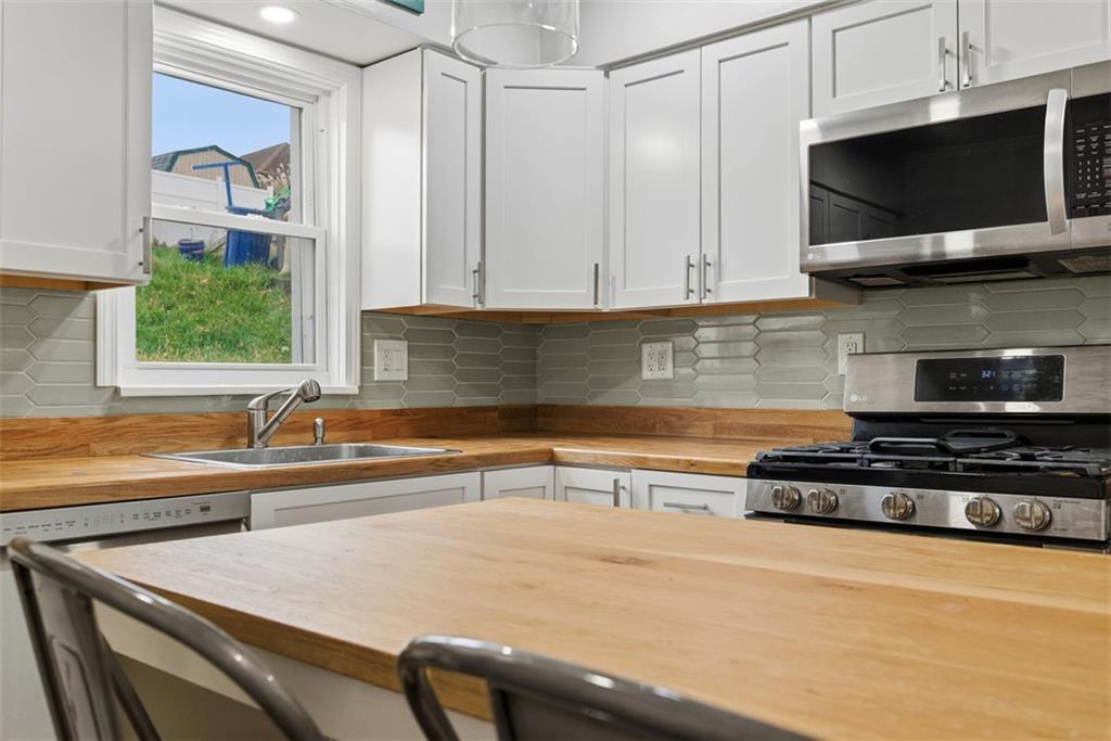 620 Montclair Street Pittsburgh, PA 15217 - Photo 16 of 40 a kitchen with stainless steel appliances granite countertop a sink a stove and microwave