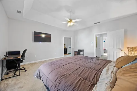 a bedroom with a bed a desk and chair