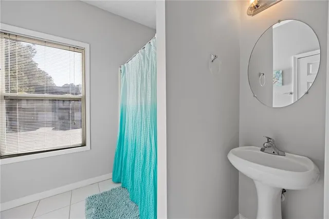 a bathroom with a sink a mirror and a window