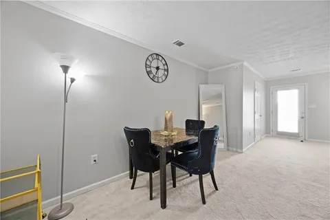 a view of a dining room with furniture and a chandelier