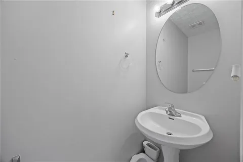 a bathroom with a sink a mirror and toilet