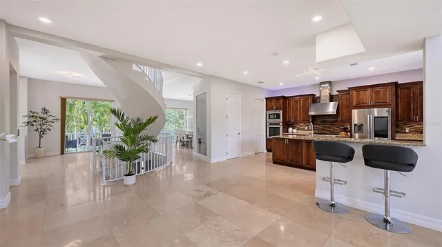 a kitchen with stainless steel appliances granite countertop a stove refrigerator and cabinets