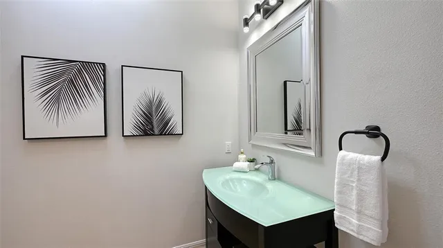 a bathroom with a double vanity sink and a mirror
