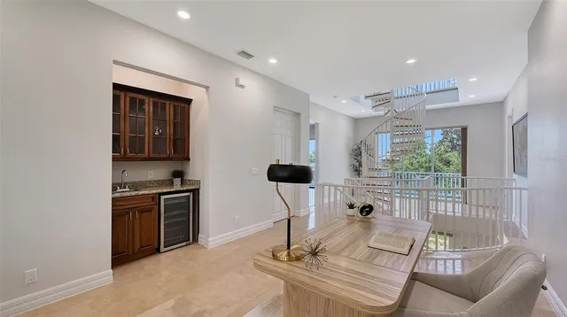 a view of staircase with railing and white walls