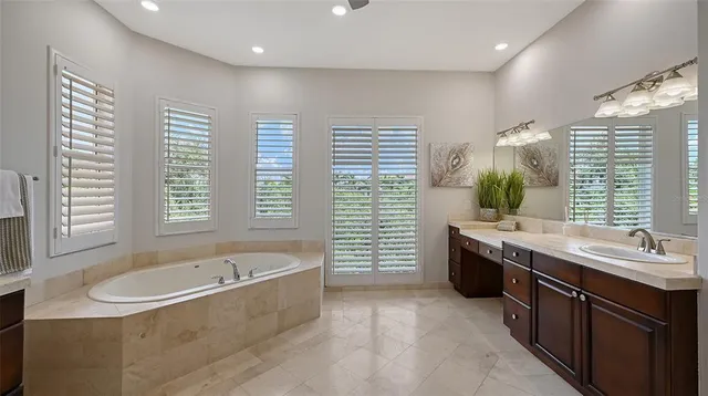 a front view of a house with garden and trees