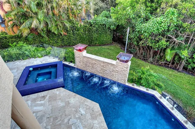 a kitchen with stainless steel appliances kitchen island granite countertop a stove a sink and a refrigerator