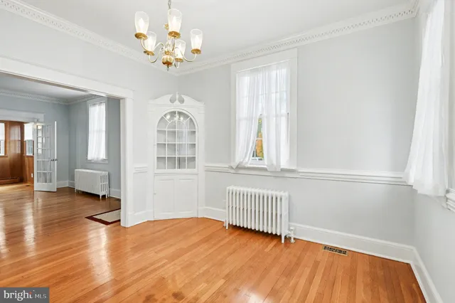 a kitchen with stainless steel appliances granite countertop a refrigerator a stove and a sink with wooden cabinets