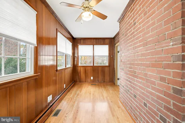 a view of empty room with fireplace and fan