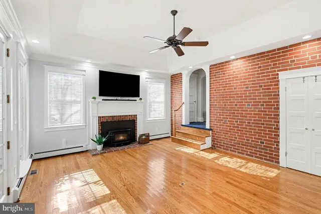 a view of an empty room with a fireplace and a window