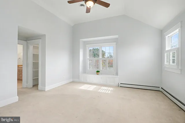 an empty room with chandelier fan