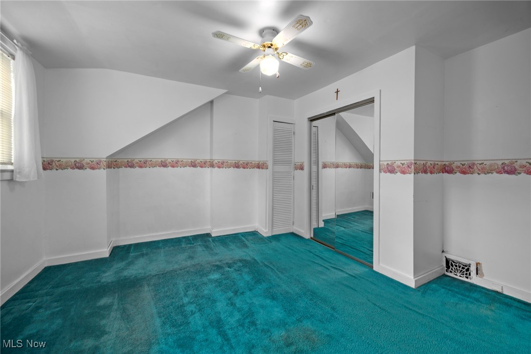 1589 Hampton Road Akron, OH 44305 - Photo 8 of 26 Bonus room with dark carpet and ceiling fan