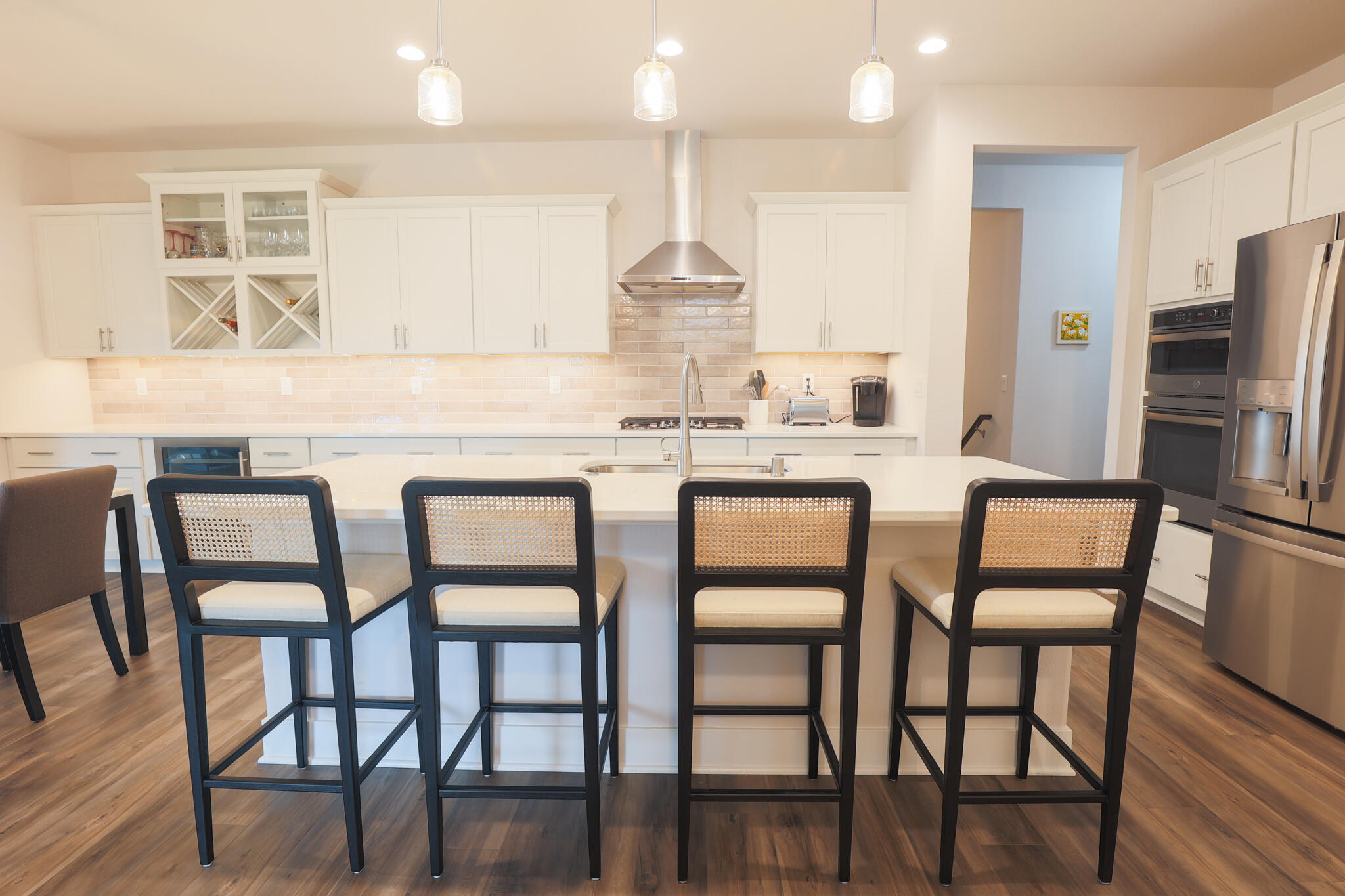 N28W25158 Pkwy Rdg Circle, Unit B Pewaukee, WI 53072 - Photo 19 of 86 Kitchen with Quartz Counters, Stainless Steel Appliances, Cooktop, and Dinette