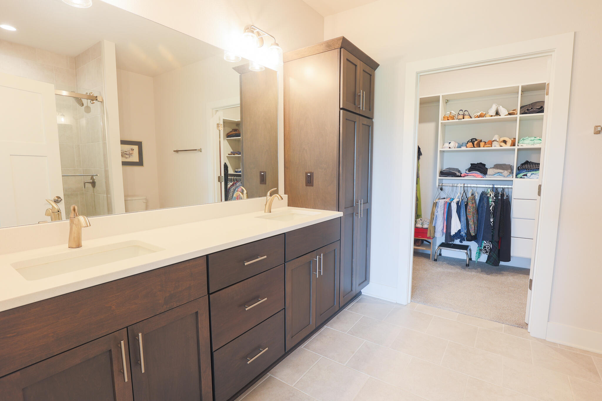 N28W25158 Pkwy Rdg Circle, Unit B Pewaukee, WI 53072 - Photo 37 of 86 Primary Bathroom with Dual Sink, Tile Shower, Tile Floor, and Walk in Closet
