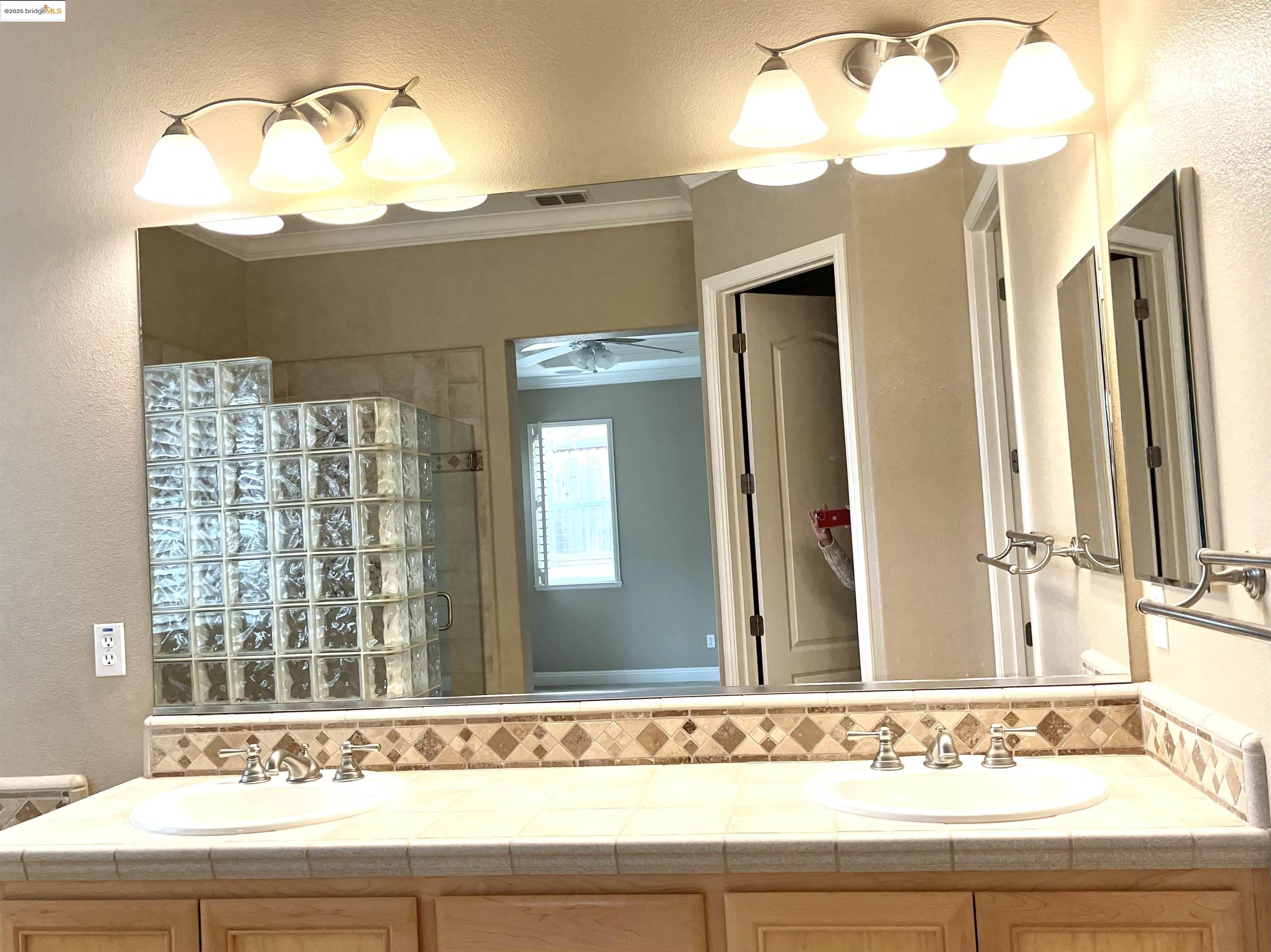 2497 Winged Foot Road Brentwood, CA 94513 - Photo 13 of 16 a bathroom with a sink a mirror and a window