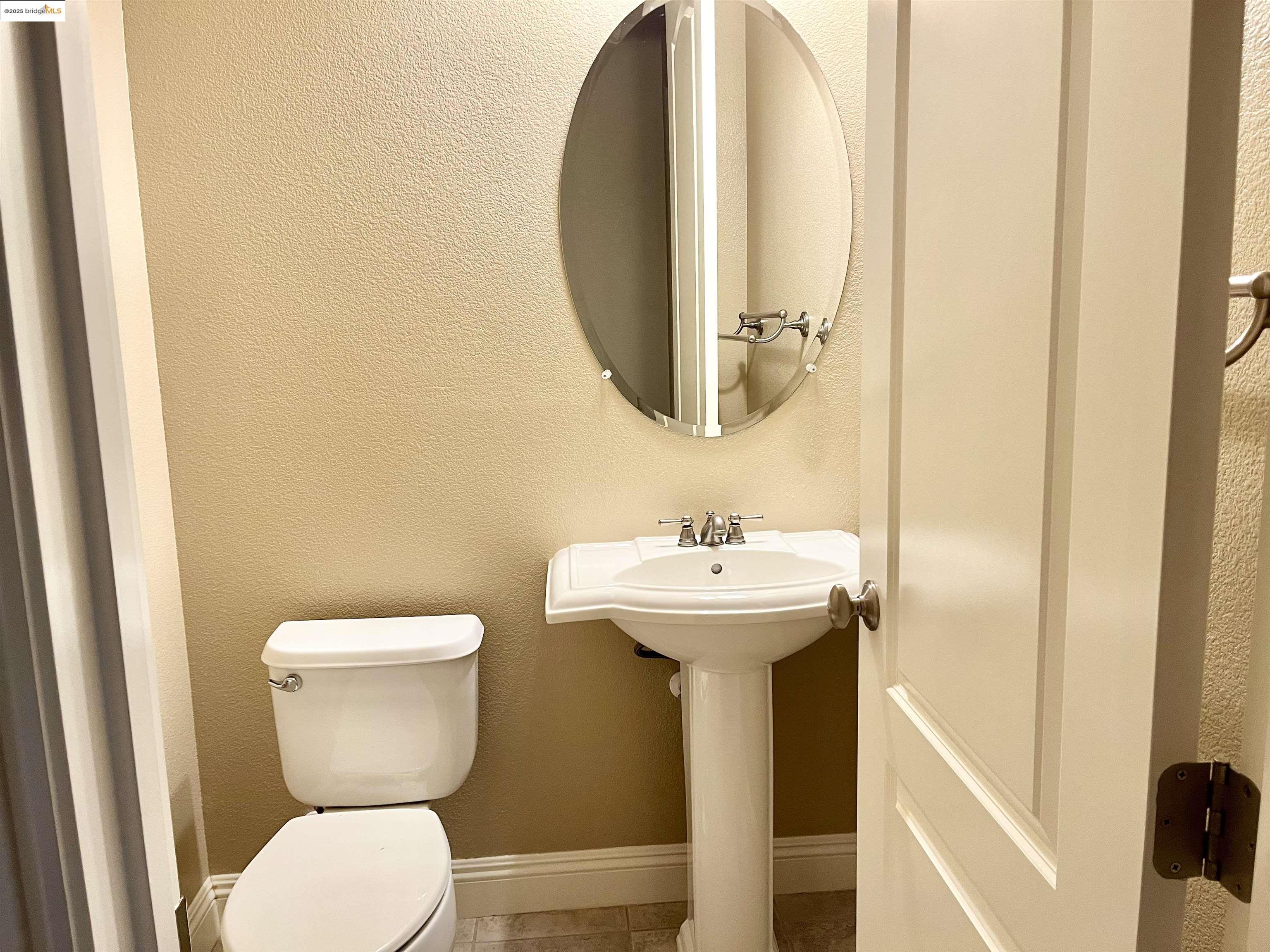 2497 Winged Foot Road Brentwood, CA 94513 - Photo 15 of 16 a bathroom with a sink and mirror with toilet