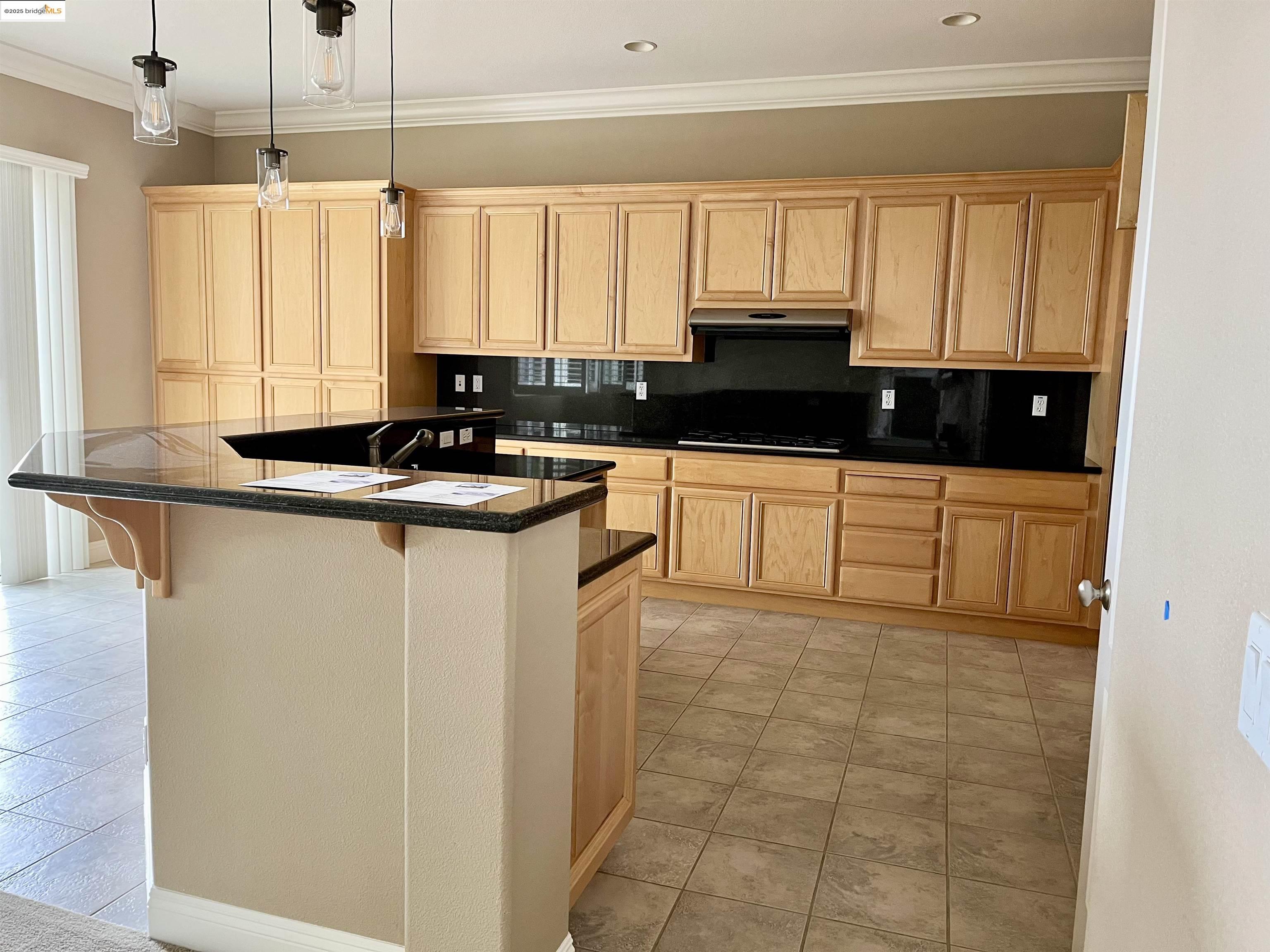 2497 Winged Foot Road Brentwood, CA 94513 - Photo 8 of 16 a kitchen with a sink a stove and cabinets