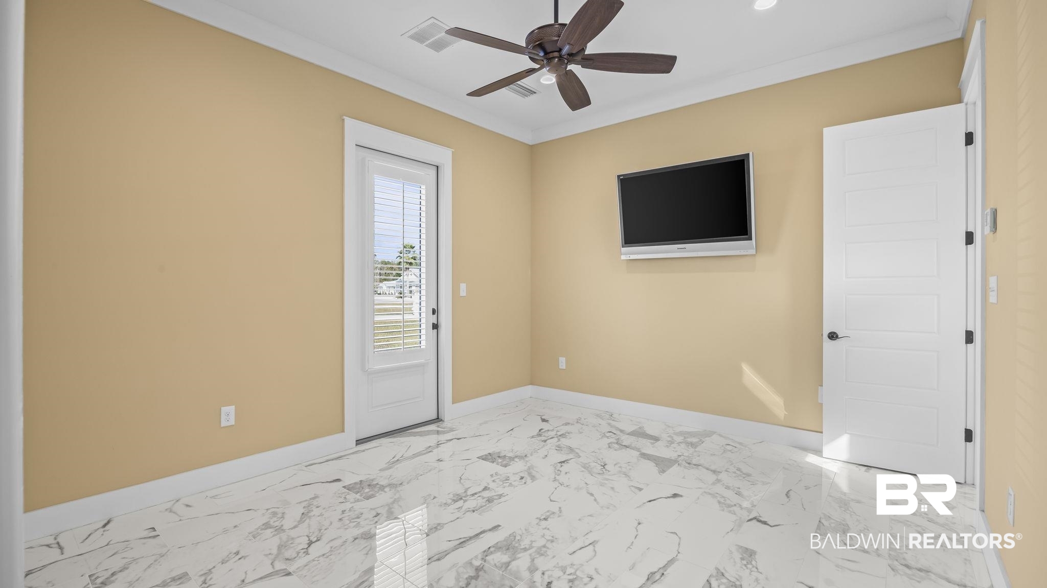 12004 Raptor Court Elberta, AL 36530 - Photo 16 of 57 Unfurnished room with light marble finish flooring, ornamental molding, and ceiling fan