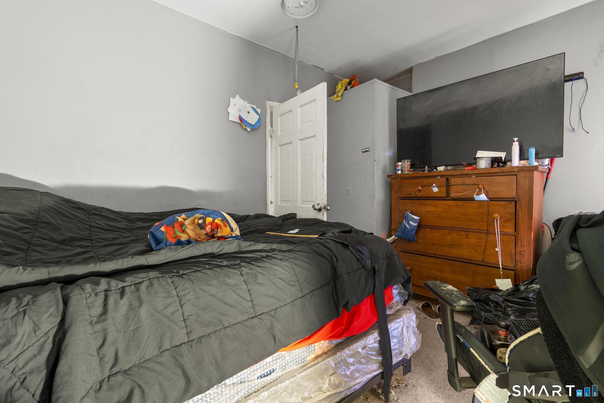 349 Noble Avenue Bridgeport, CT 06608 - Photo 13 of 33 a bed sitting in a bedroom and dresser
