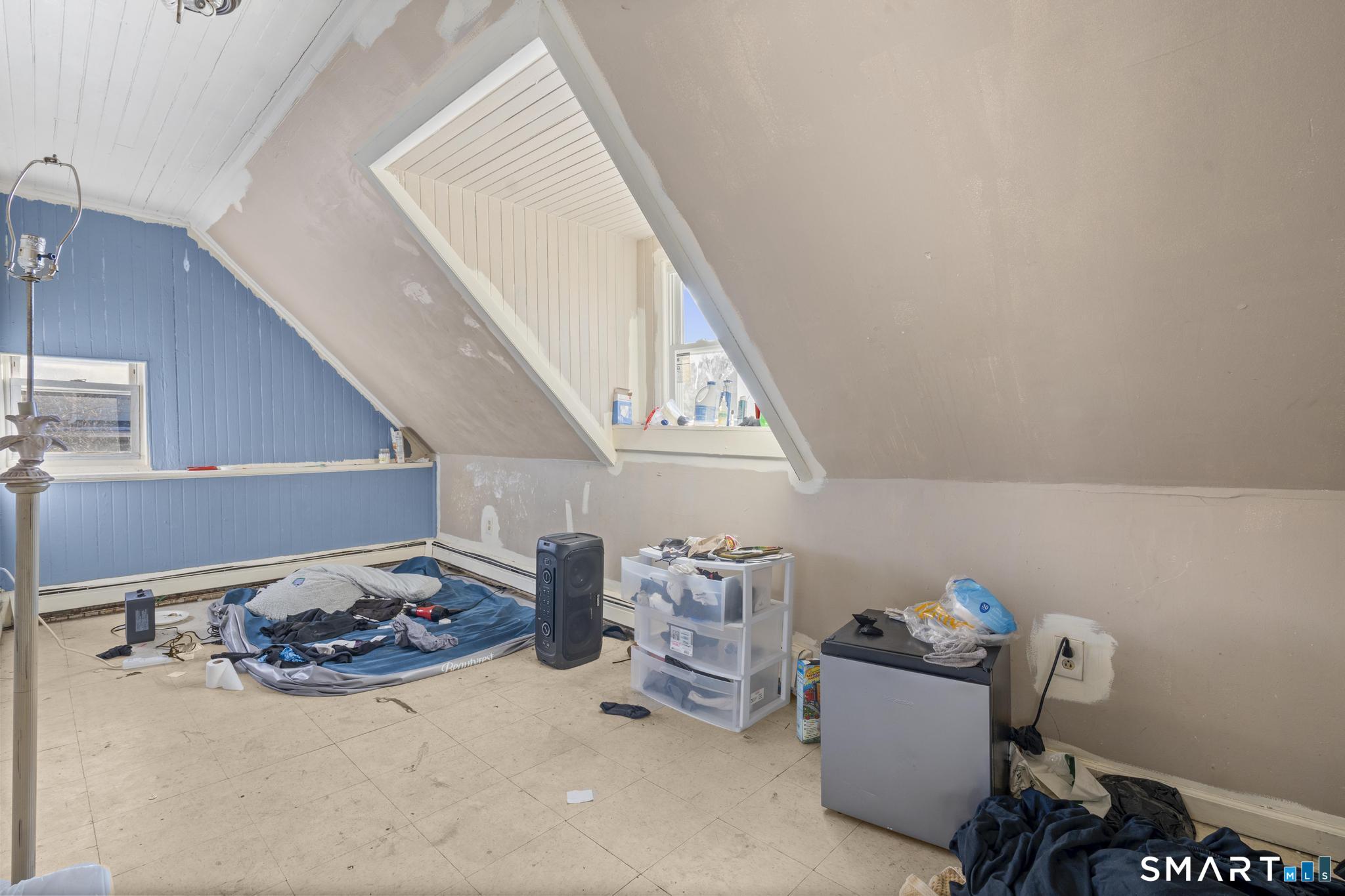 349 Noble Avenue Bridgeport, CT 06608 - Photo 15 of 33 a room with a baby crib and a couch