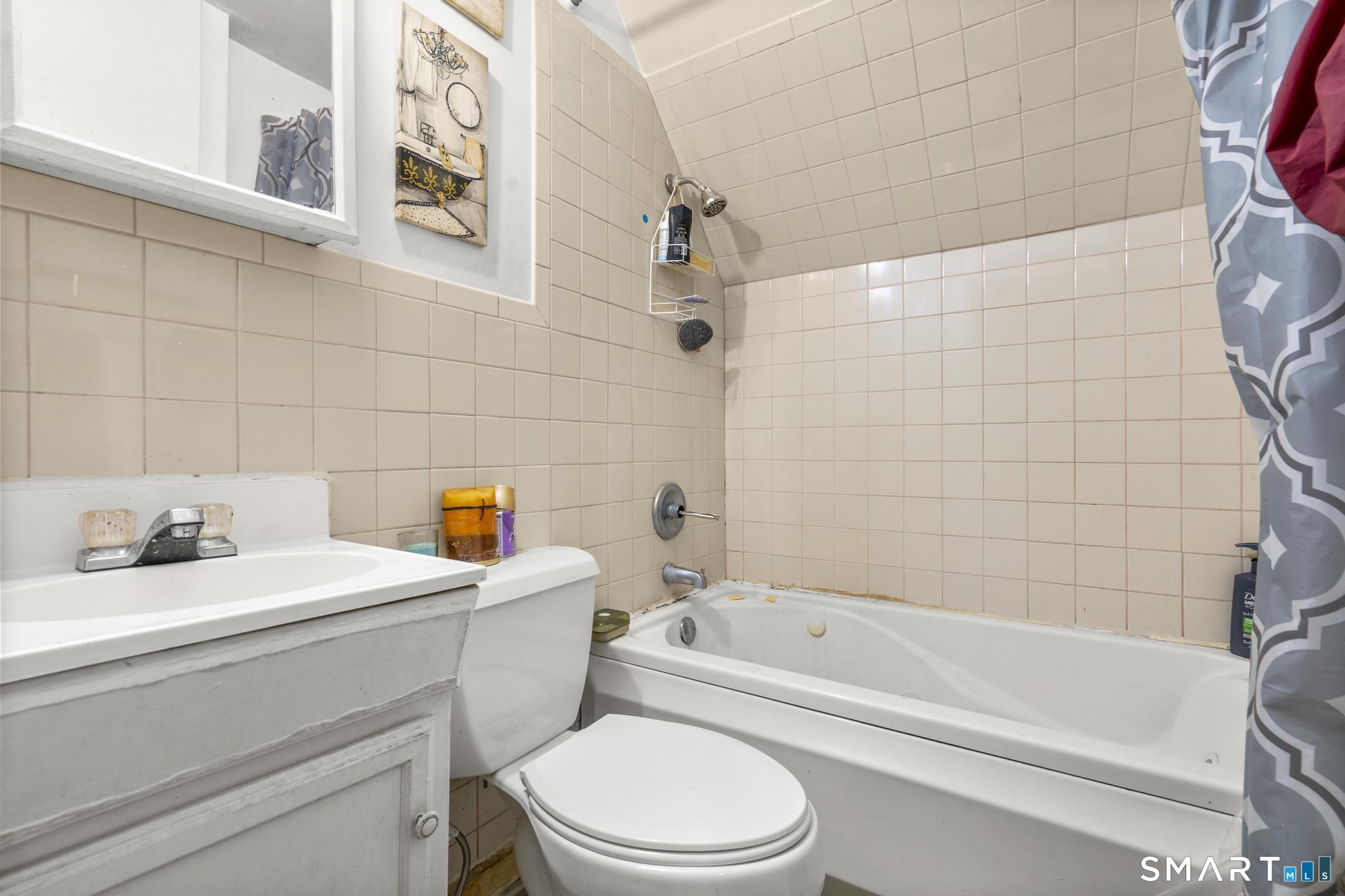 349 Noble Avenue Bridgeport, CT 06608 - Photo 17 of 33 a bathroom with a sink a toilet and a bathtub