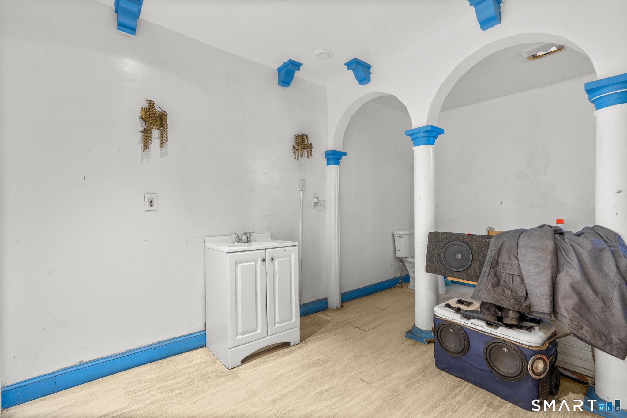 349 Noble Avenue Bridgeport, CT 06608 - Photo 20 of 33 a bedroom with a bed and a chandelier
