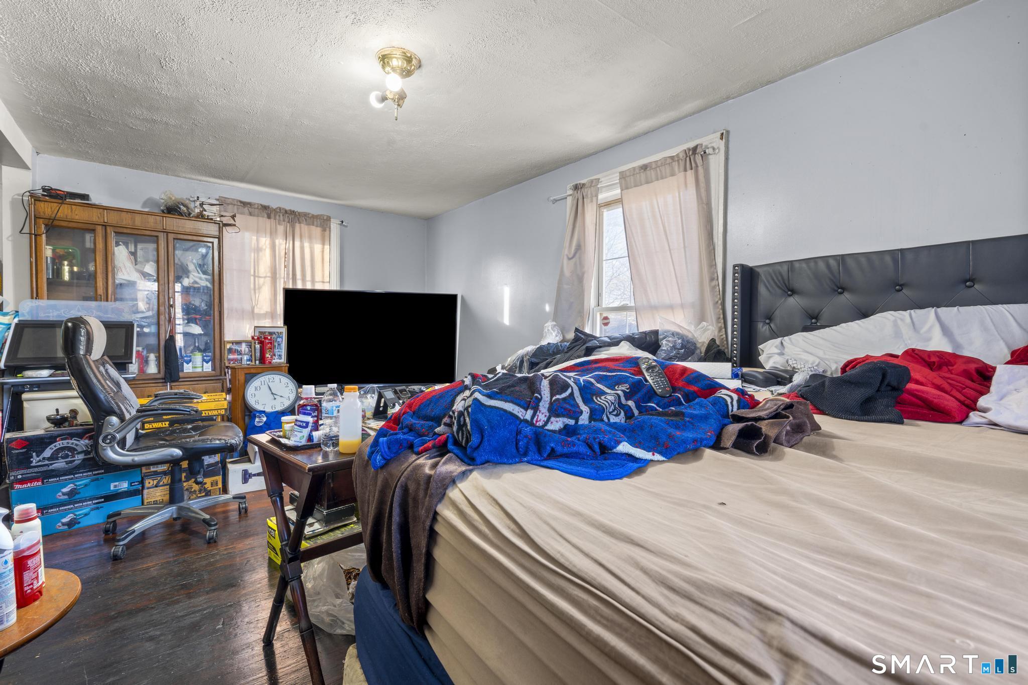 349 Noble Avenue Bridgeport, CT 06608 - Photo 26 of 33 a bedroom with a bed and a flat screen tv