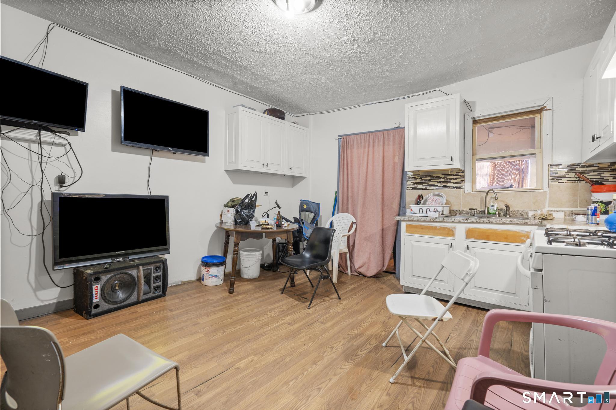 349 Noble Avenue Bridgeport, CT 06608 - Photo 30 of 33 a view of a livingroom with furniture and a flat screen tv