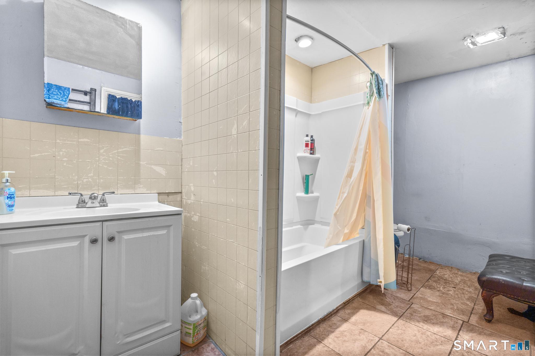 349 Noble Avenue Bridgeport, CT 06608 - Photo 32 of 33 a bathroom with a tub and a sink