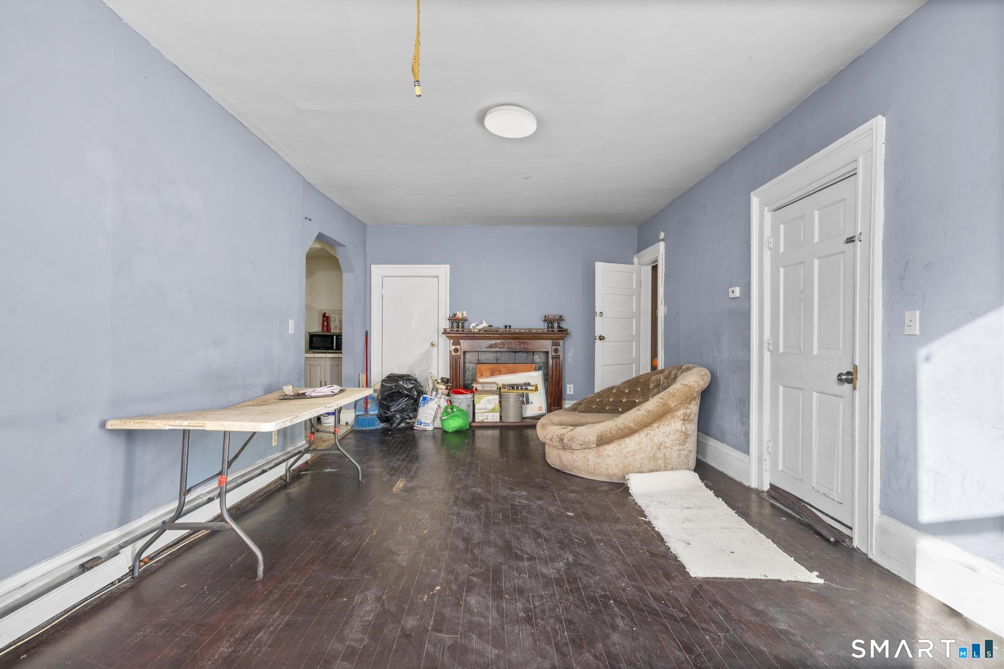 349 Noble Avenue Bridgeport, CT 06608 - Photo 6 of 33 a living room with furniture and a fireplace
