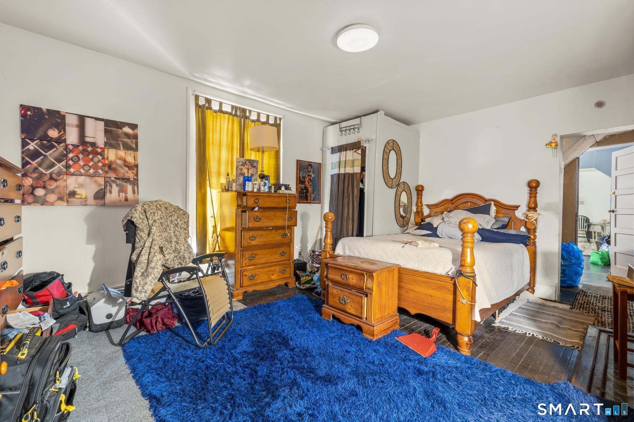 349 Noble Avenue Bridgeport, CT 06608 - Photo 10 of 33 a bedroom with furniture and a wooden floor