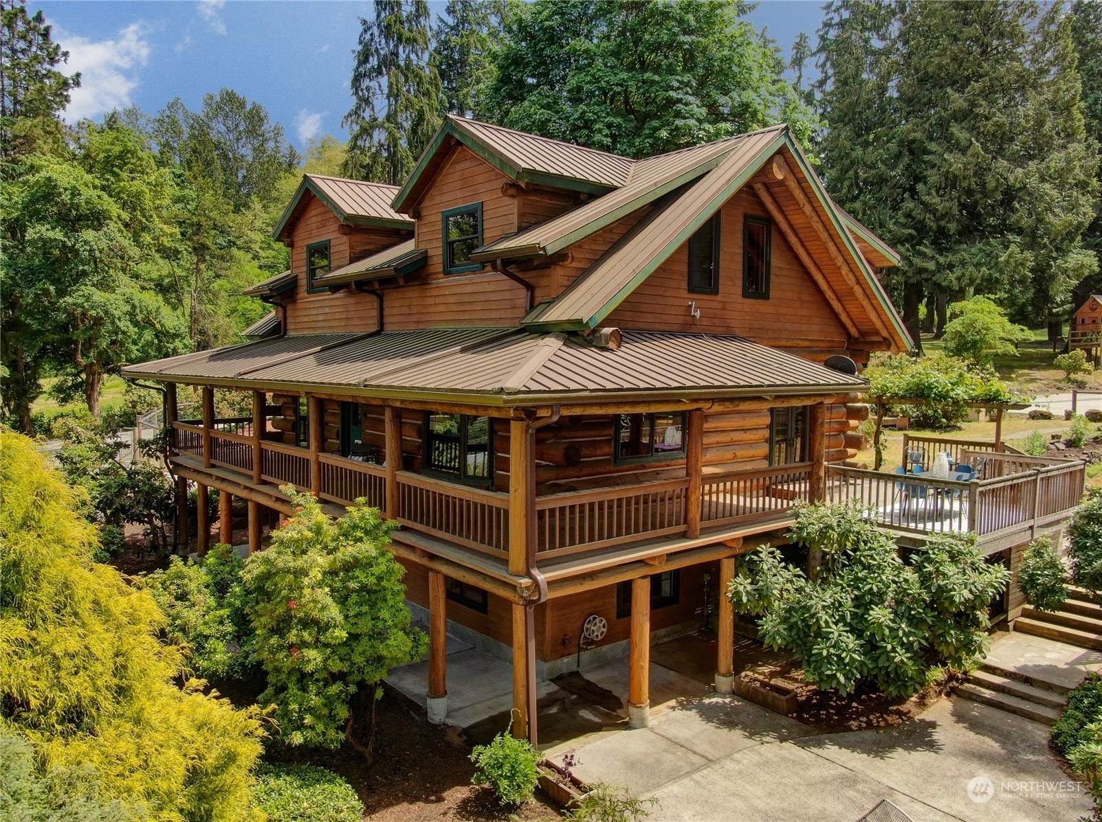 18724 High Rock Road Monroe, WA 98272 - Photo 3 of 39 a front view of a house with a yard garage and outdoor seating