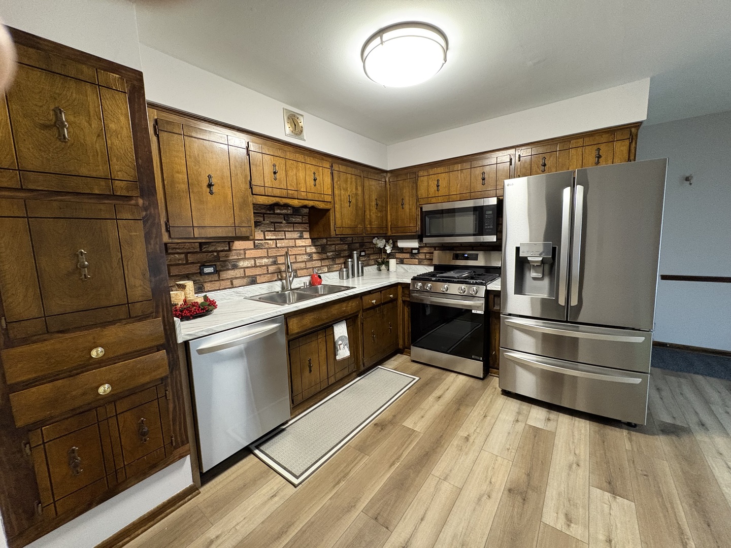 4937 West 85th Place Burbank, IL 60459 - Photo 2 of 12 a kitchen with kitchen island wooden cabinets and stainless steel appliances