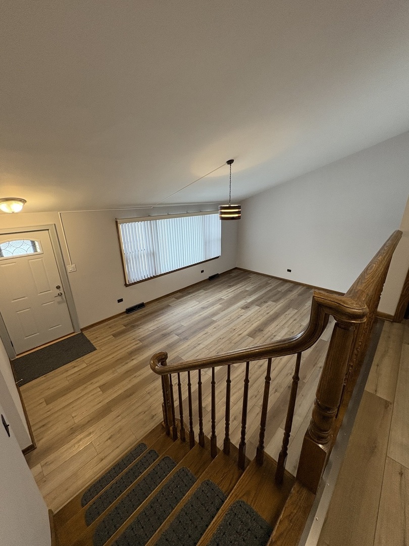 4937 West 85th Place Burbank, IL 60459 - Photo 4 of 12 a view of a room with wooden floor