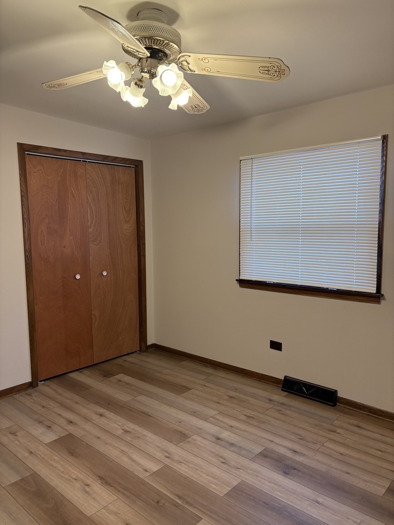 4937 West 85th Place Burbank, IL 60459 - Photo 6 of 12 a view of a room with wooden floor and fan