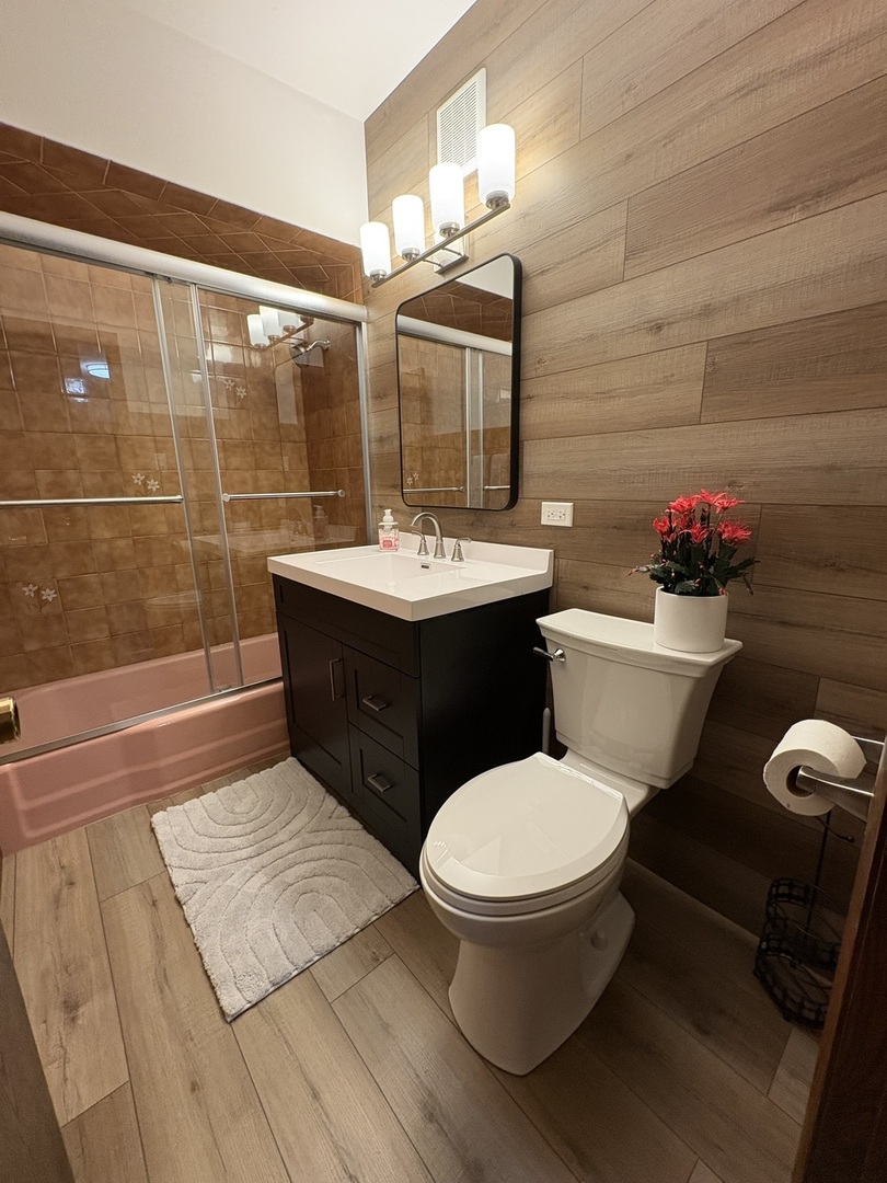 4937 West 85th Place Burbank, IL 60459 - Photo 7 of 12 a bathroom with a sink toilet and shower