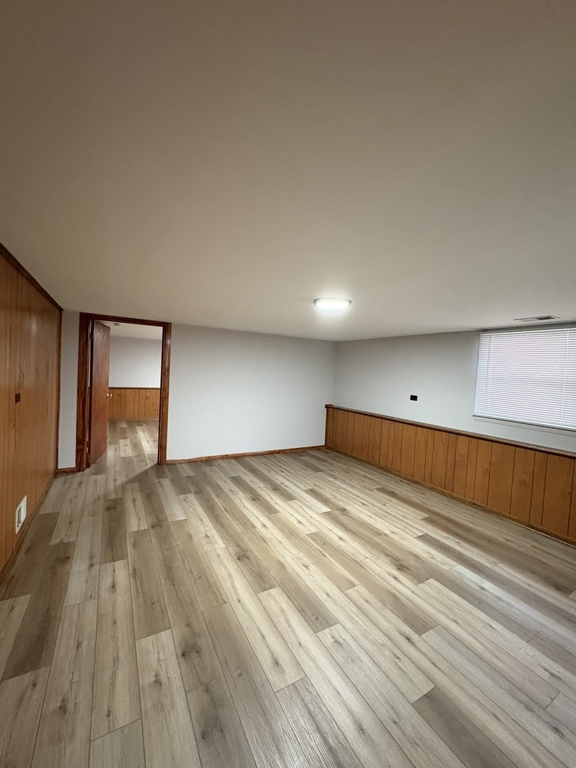 4937 West 85th Place Burbank, IL 60459 - Photo 8 of 12 a view of empty room with wooden floor