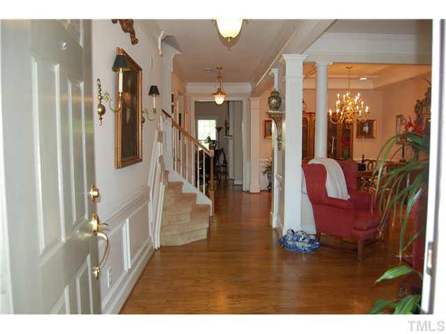 Entry Foyer w/oak hard wood floors (HW all through first floor except Office, 1/2 BA & utility room), ceiling chandelier & matching hall chandelier, open to FLR, custom wainscoting & extensive crown molding! Foyer