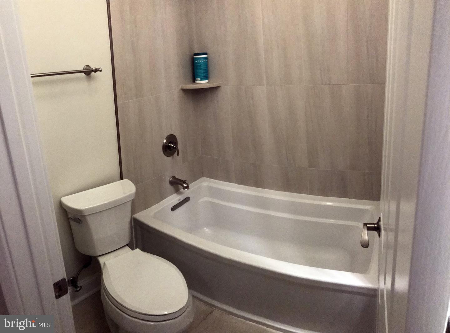 3925 Fulton Street Northwest, Unit 5 Washington, DC 20007 - Photo 14 of 19 a white toilet sitting next to a bath tub
