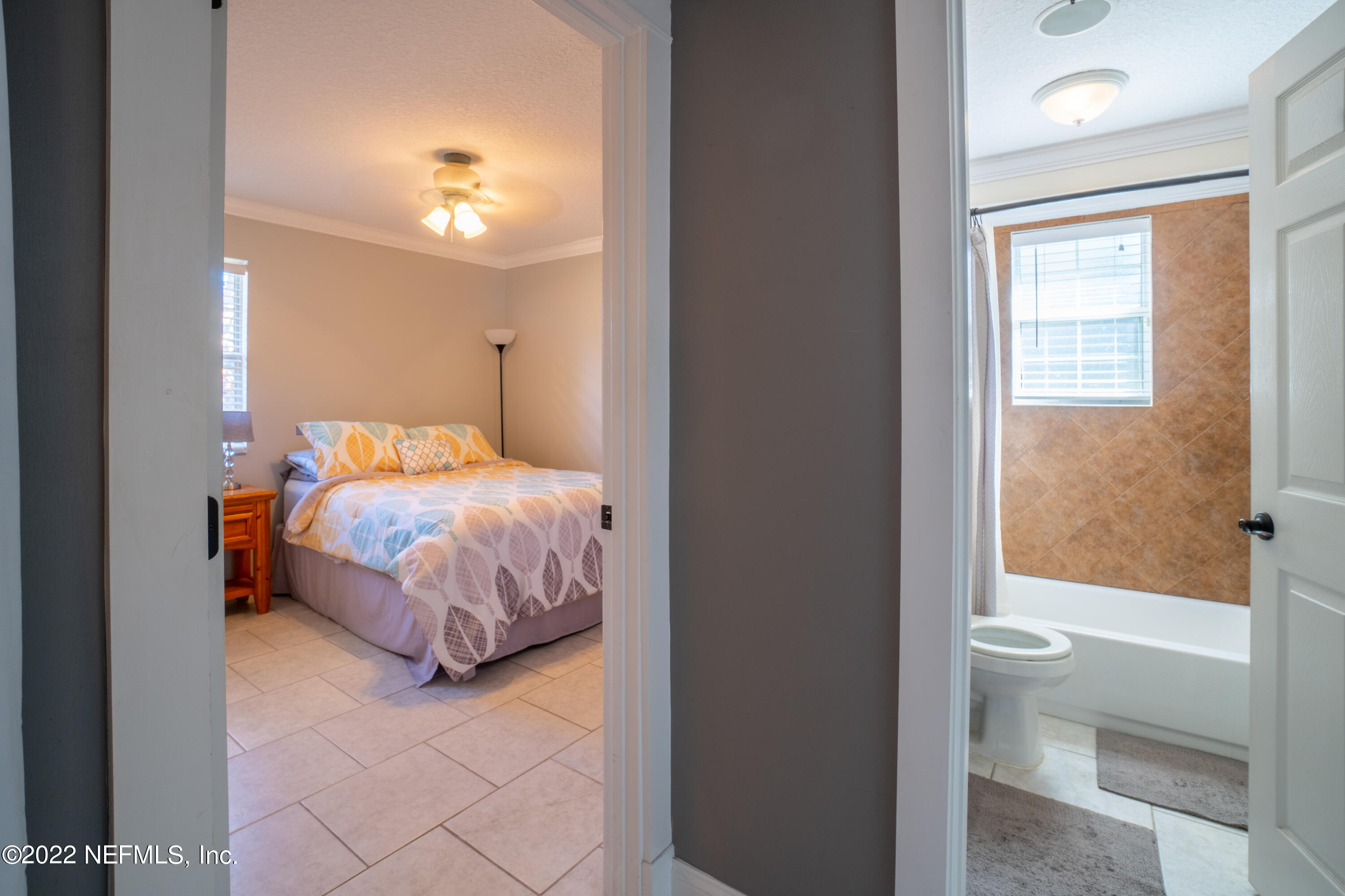 115 Nautilus Road St. Augustine, FL 32086 - Photo 15 of 23 a bedroom with a bed and a view of bathroom