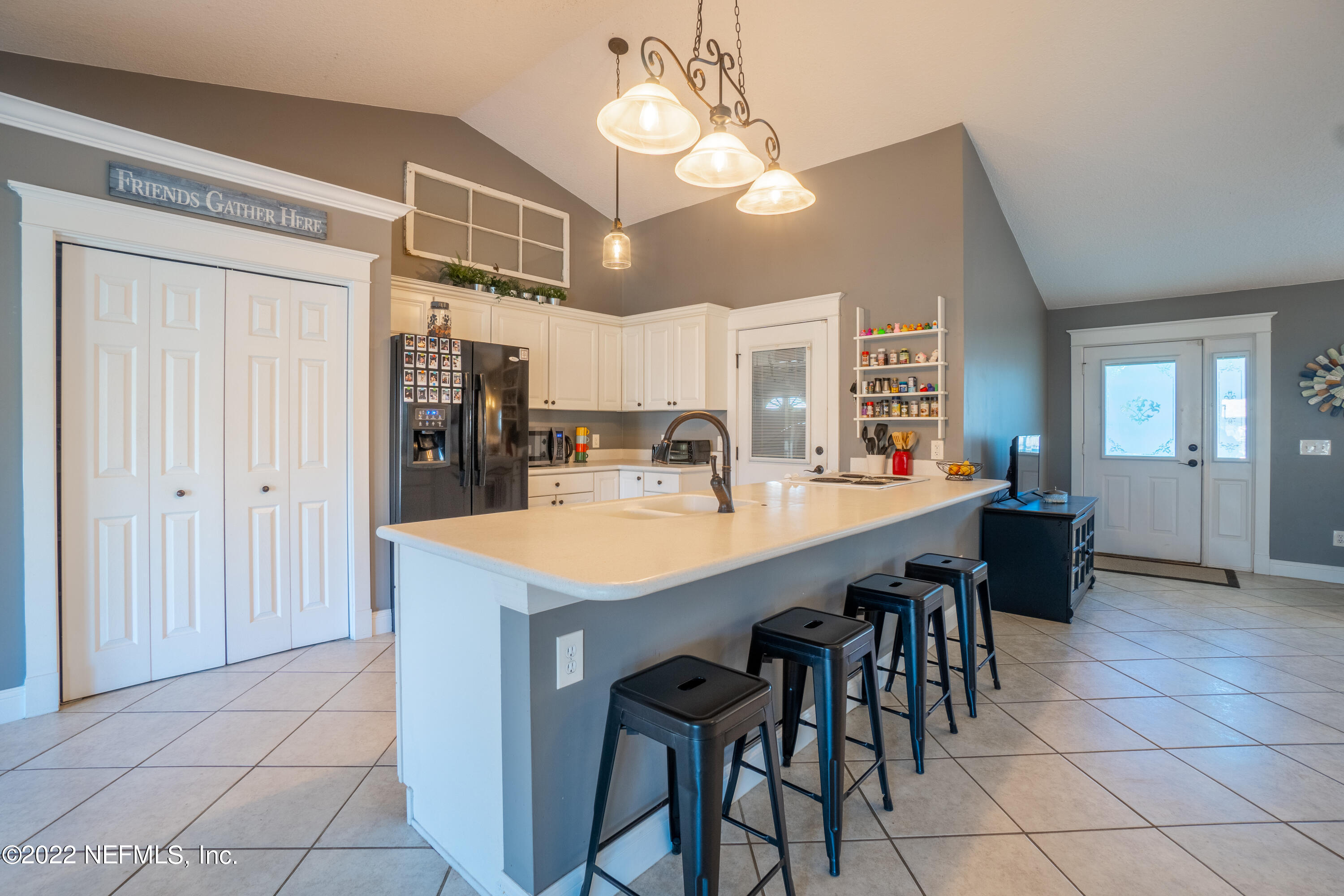 115 Nautilus Road St. Augustine, FL 32086 - Photo 20 of 23 a kitchen with stainless steel appliances kitchen island granite countertop a dining table chairs and granite counter tops
