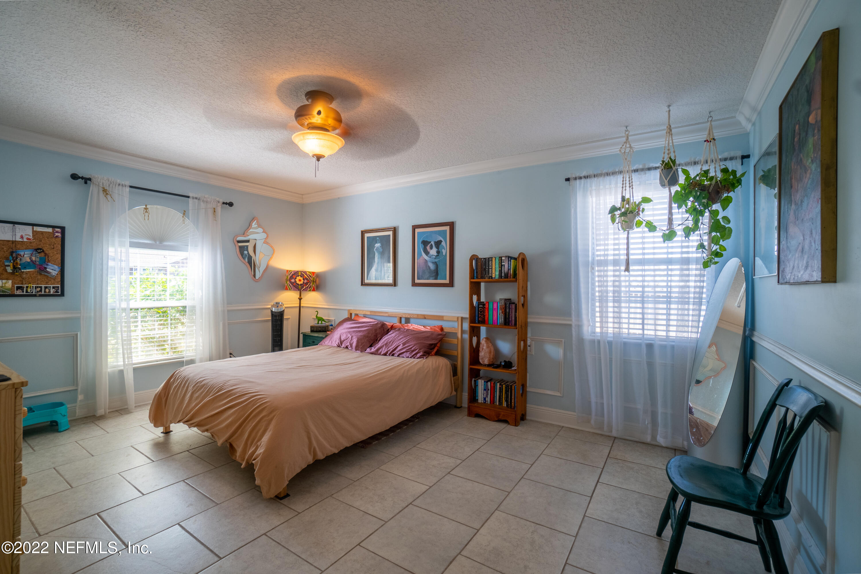 115 Nautilus Road St. Augustine, FL 32086 - Photo 7 of 23 a bedroom with a bed a chandelier and a window
