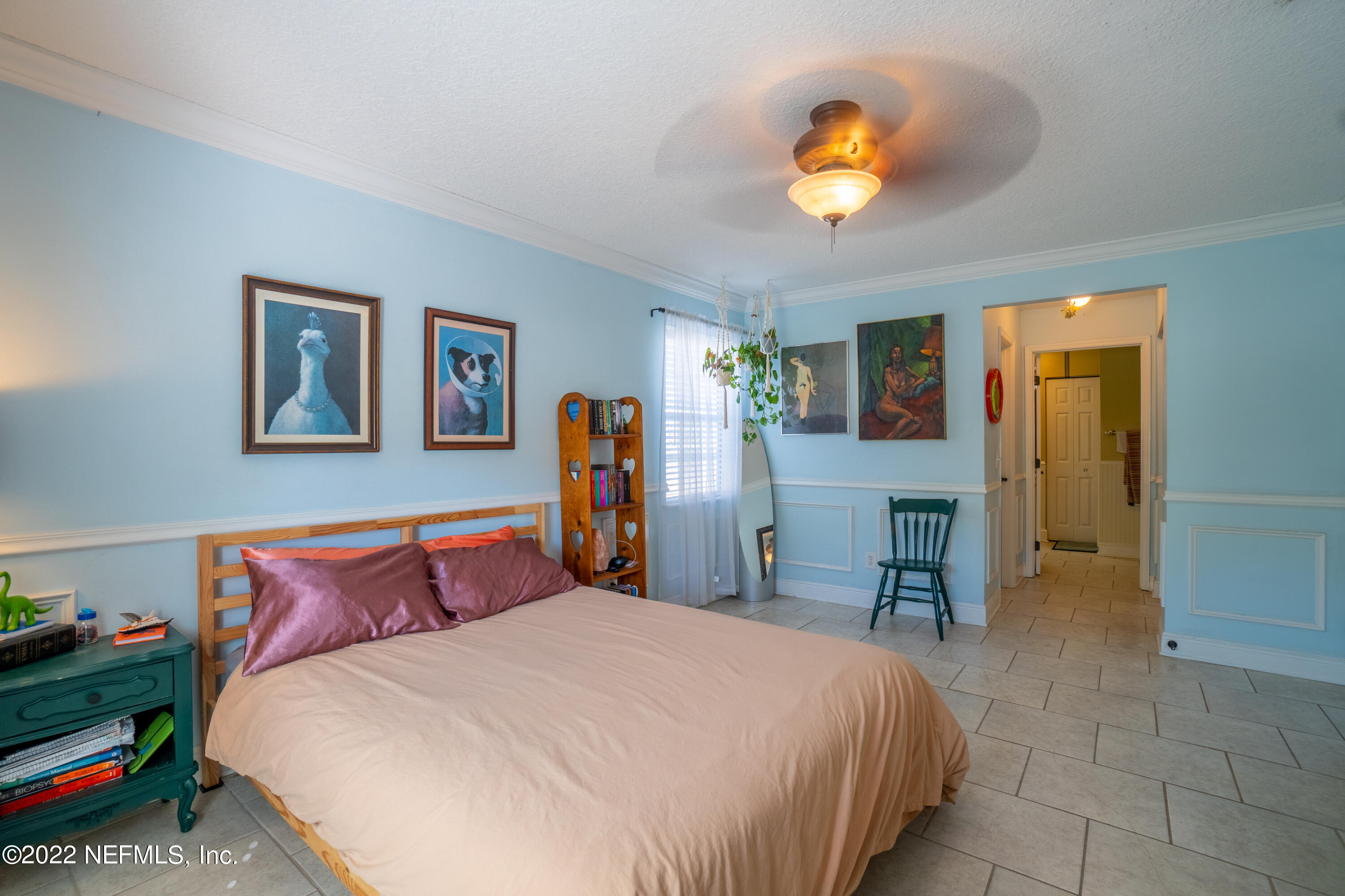115 Nautilus Road St. Augustine, FL 32086 - Photo 8 of 23 a bedroom with a bed and a chandelier