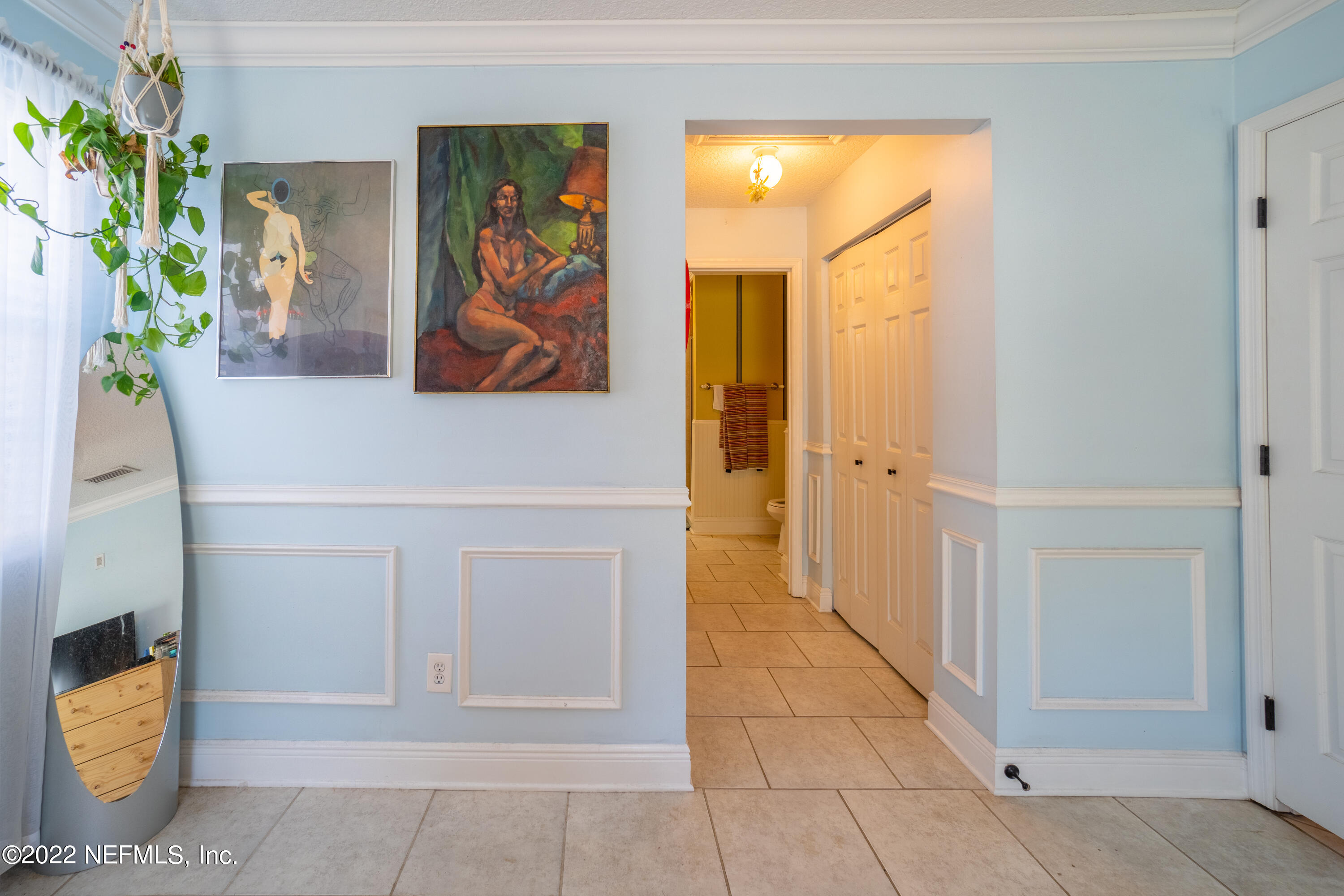 115 Nautilus Road St. Augustine, FL 32086 - Photo 9 of 23 a view of a hallway with wooden floor and a potted plant