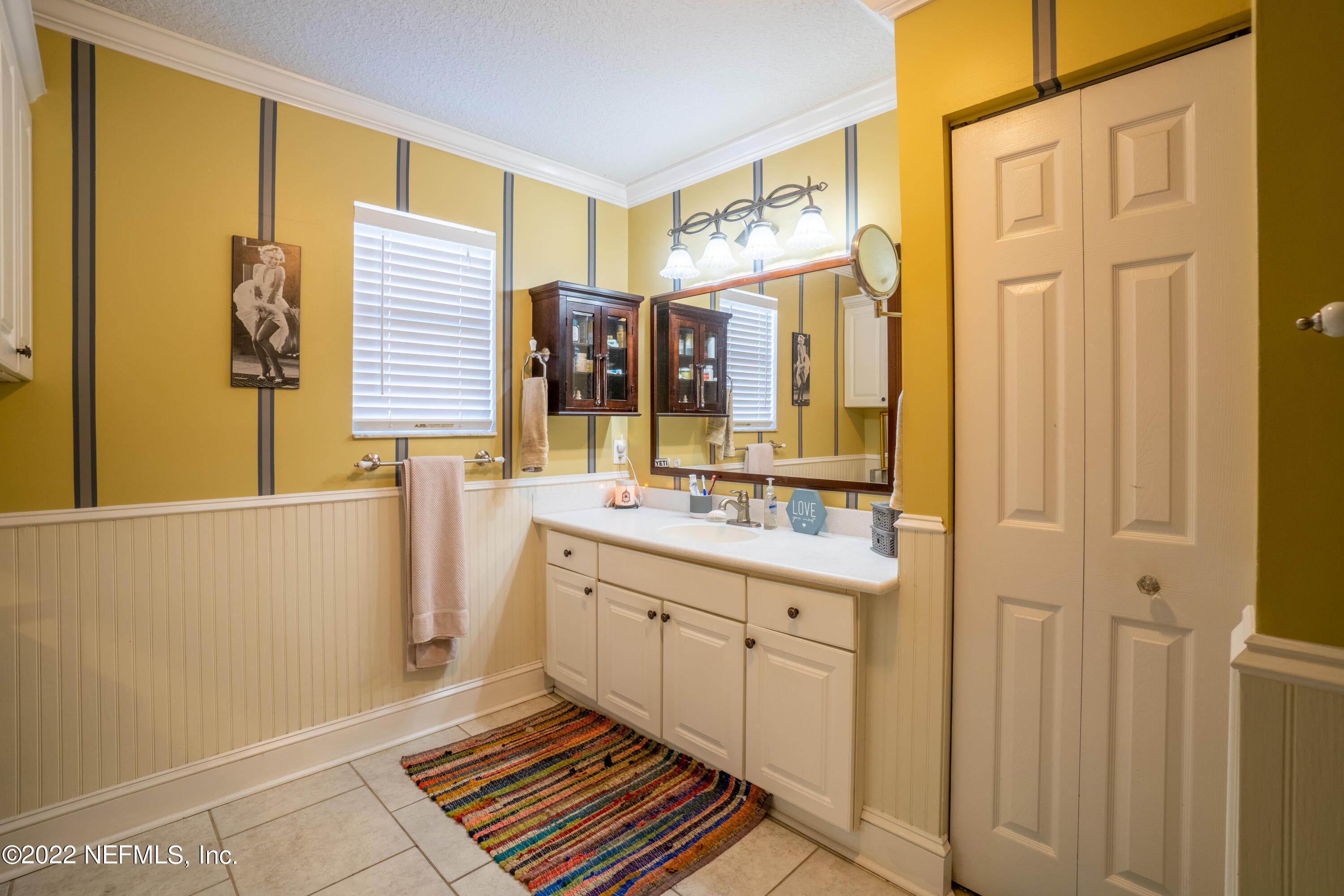 115 Nautilus Road St. Augustine, FL 32086 - Photo 10 of 23 a bathroom with a sink a mirror and a shower