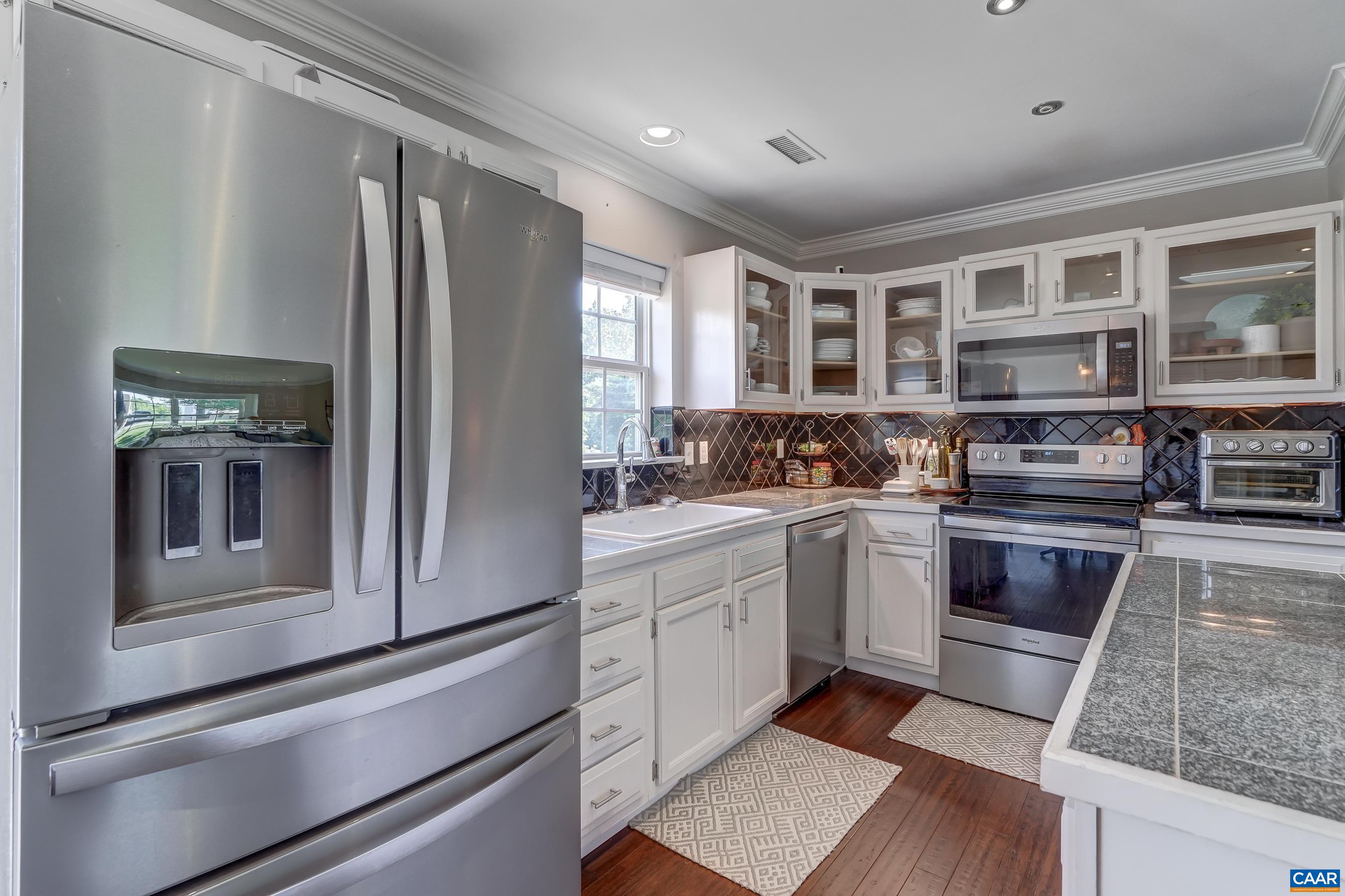 1069 Amber Ridge Road Charlottesville, VA 22901 - Photo 15 of 46 a kitchen with stainless steel appliances granite countertop a refrigerator and a stove top oven