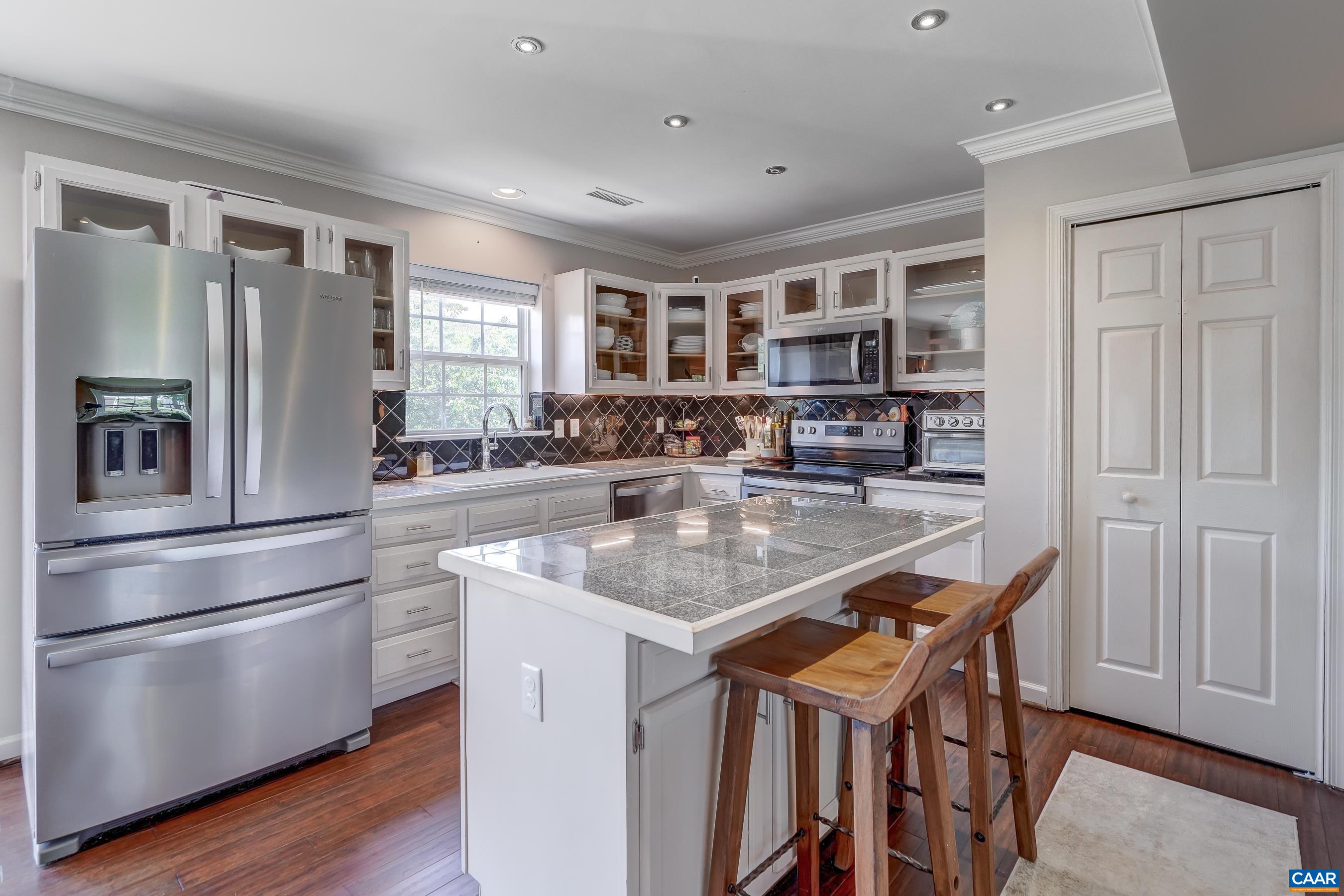 1069 Amber Ridge Road Charlottesville, VA 22901 - Photo 16 of 46 a kitchen with stainless steel appliances granite countertop a refrigerator and a stove top oven