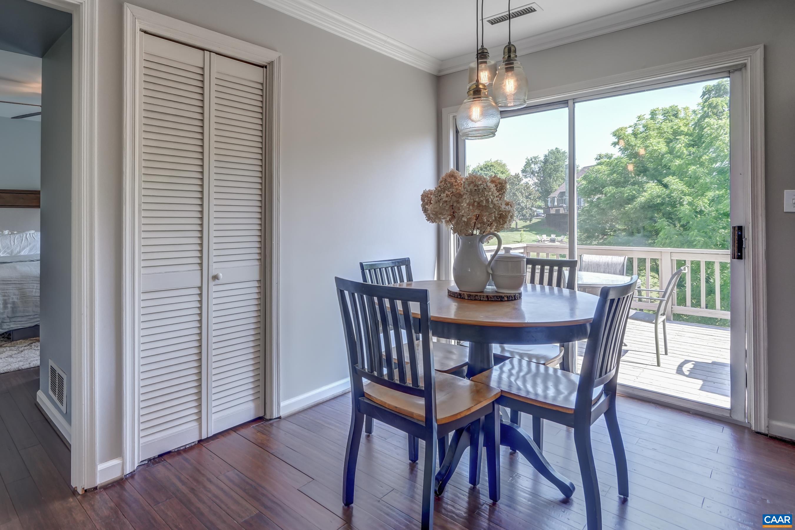 1069 Amber Ridge Road Charlottesville, VA 22901 - Photo 17 of 46 a view of a dining room with furniture window and wooden floor