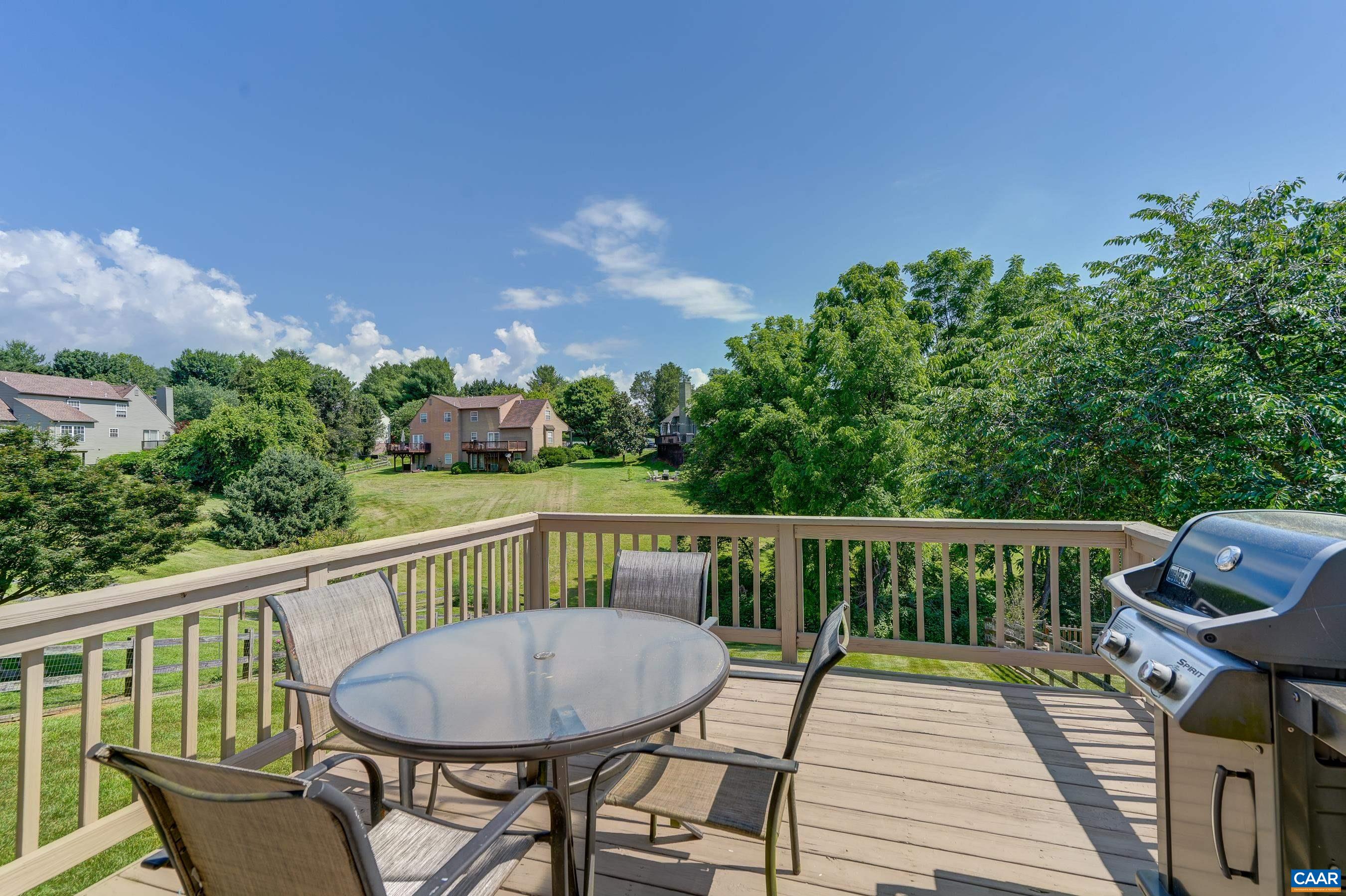 1069 Amber Ridge Road Charlottesville, VA 22901 - Photo 19 of 46 a view of a deck with two chairs and a table