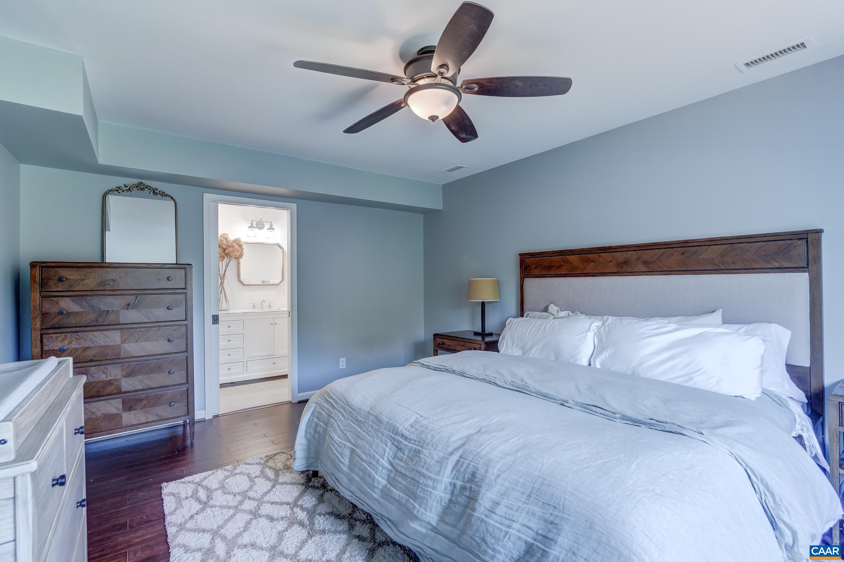 1069 Amber Ridge Road Charlottesville, VA 22901 - Photo 21 of 46 a bedroom with a bed and wooden floor